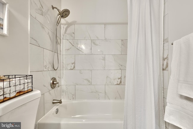 bathroom with shower / bath combo and toilet