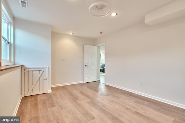 empty room with light wood-type flooring and ceiling fan