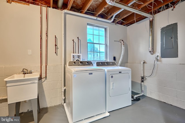 laundry area featuring washer and clothes dryer, electric panel, and sink