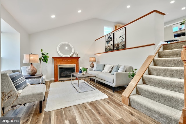 living room featuring vaulted ceiling and light hardwood / wood-style floors