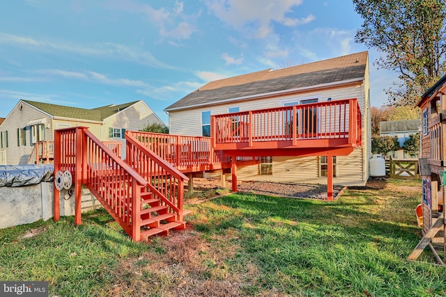 rear view of house with a lawn and a deck