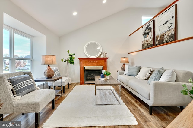 living room featuring hardwood / wood-style floors and vaulted ceiling