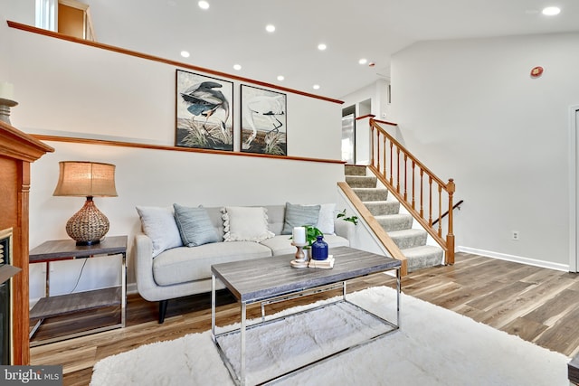 living room featuring vaulted ceiling and light hardwood / wood-style flooring