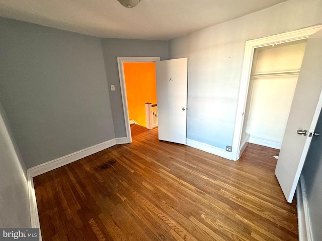 unfurnished bedroom with a closet and wood-type flooring