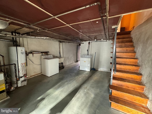 basement featuring water heater and washer / clothes dryer