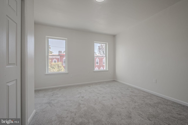 unfurnished room with light carpet