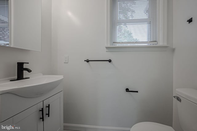 bathroom featuring vanity and toilet