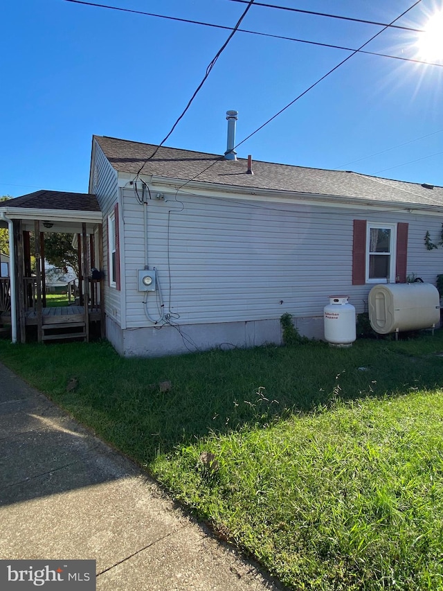 view of side of home featuring a yard