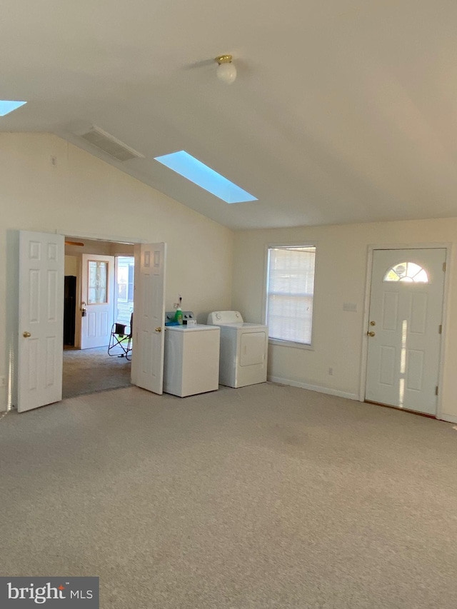 9 Cypress Pl, Indian Head, MD 20640 - unfurnished living room with a skylight, washer and dryer, light carpet, vaulted ceiling, and plenty of natural light