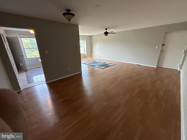 unfurnished living room with hardwood / wood-style flooring and ceiling fan