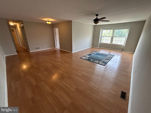 unfurnished living room featuring hardwood / wood-style flooring and ceiling fan