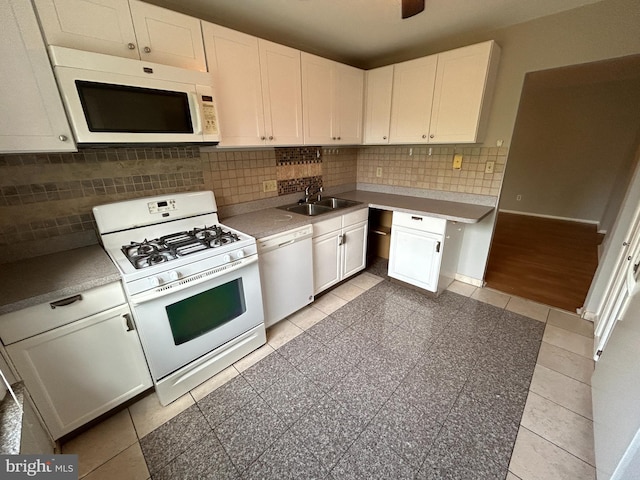 kitchen featuring white cabinets, white appliances, sink, and tasteful backsplash