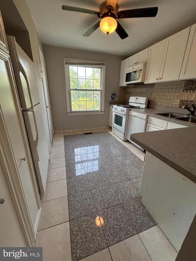 kitchen featuring white cabinetry, sink, ceiling fan, white appliances, and decorative backsplash