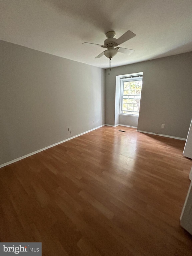 unfurnished room featuring hardwood / wood-style flooring and ceiling fan