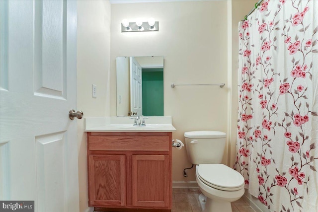 bathroom with curtained shower, tile patterned flooring, vanity, and toilet