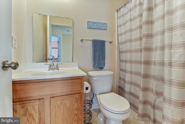 bathroom with vanity, tile patterned floors, and toilet