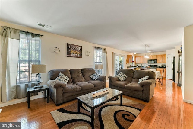 living room with light hardwood / wood-style flooring