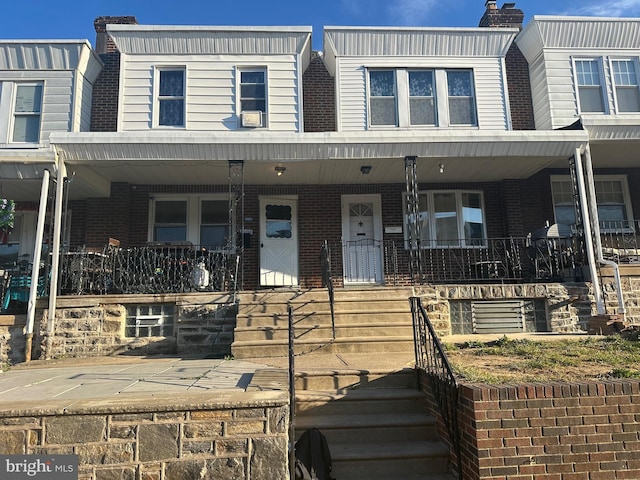 townhome / multi-family property with a porch