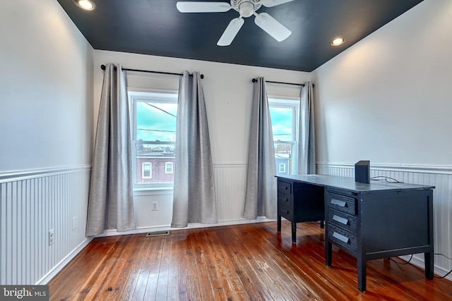 home office featuring a wealth of natural light, dark hardwood / wood-style floors, and ceiling fan