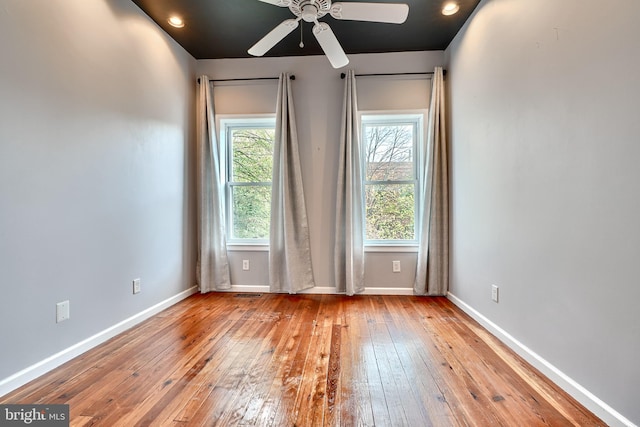 spare room with light wood-type flooring and ceiling fan