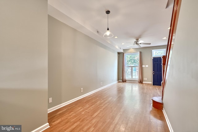 empty room with light hardwood / wood-style flooring and ceiling fan