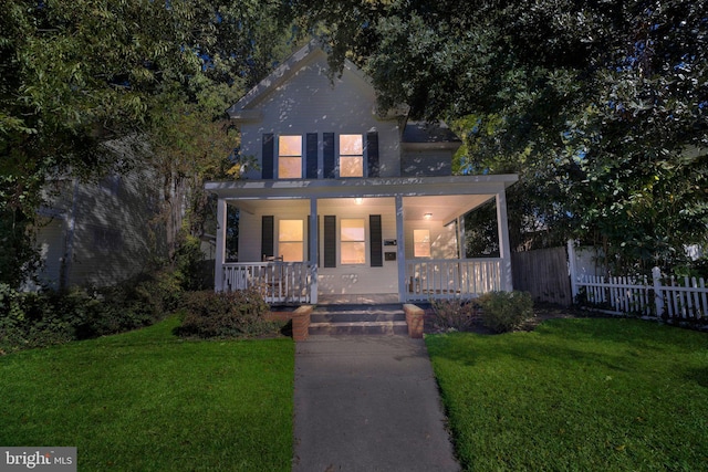 view of front of home featuring covered porch and a front yard