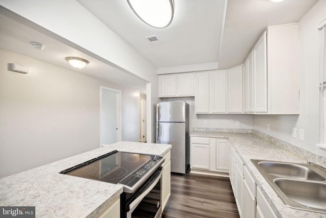 kitchen featuring sink, dark hardwood / wood-style flooring, white cabinets, and appliances with stainless steel finishes