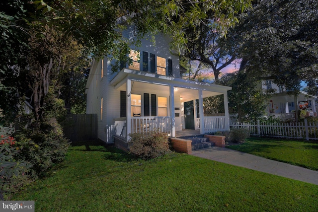 view of front of house featuring a lawn and a porch