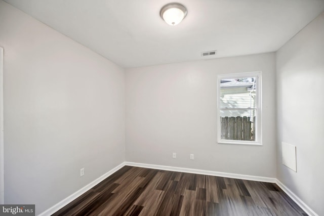 unfurnished room featuring dark hardwood / wood-style floors