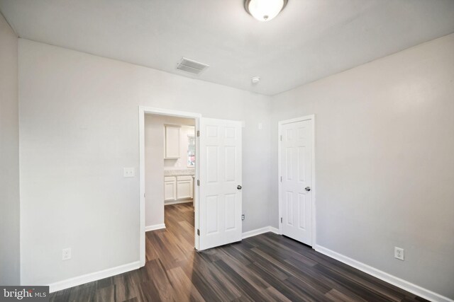 spare room featuring dark hardwood / wood-style floors