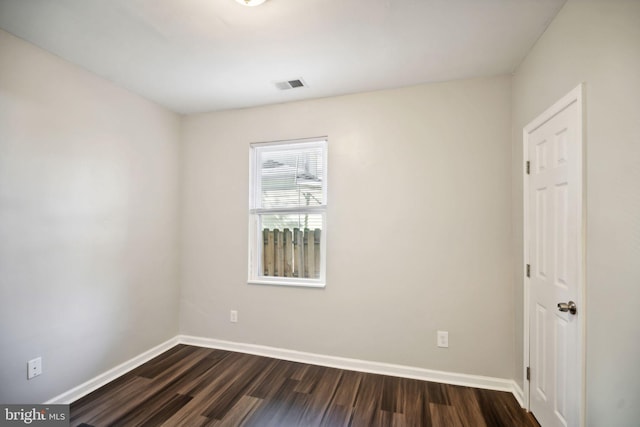 spare room with dark wood-type flooring