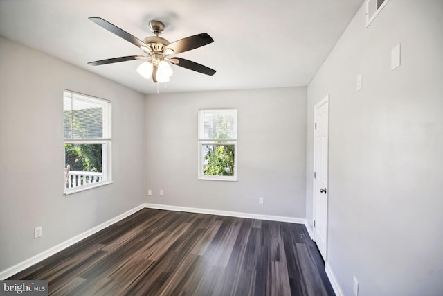 unfurnished room with plenty of natural light, dark wood-type flooring, and ceiling fan