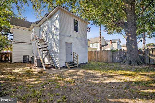 rear view of property with cooling unit