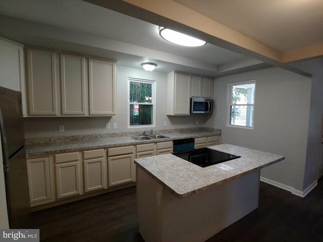 kitchen with sink, black appliances, white cabinetry, dark hardwood / wood-style floors, and a kitchen island