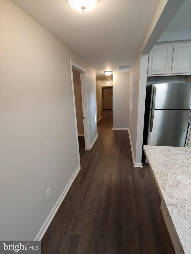 corridor with dark hardwood / wood-style floors