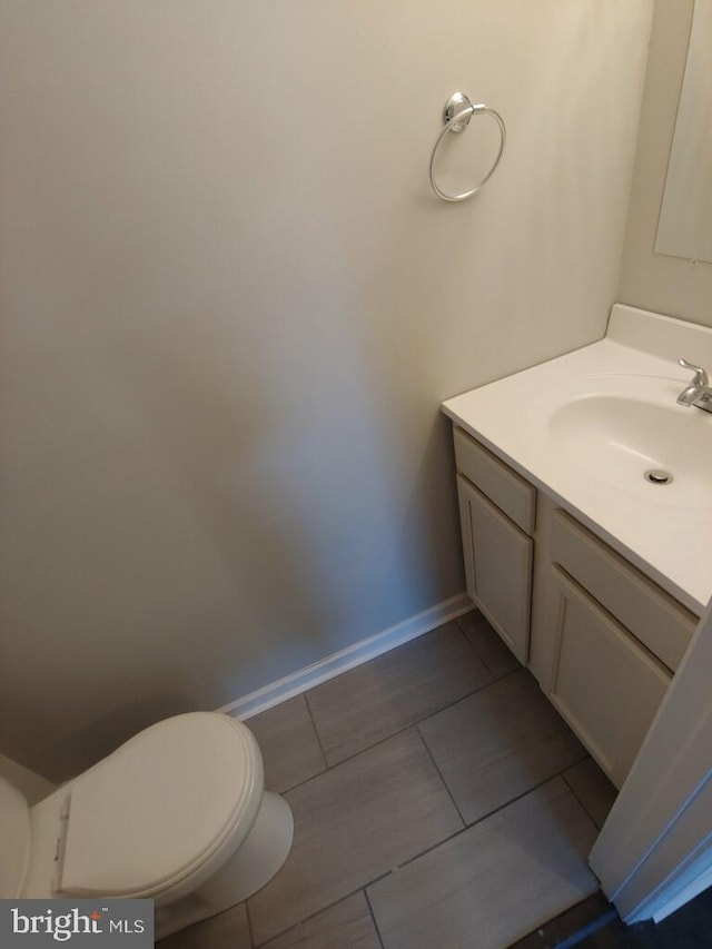 bathroom with tile patterned floors, vanity, and toilet