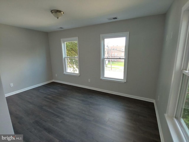 unfurnished room with dark hardwood / wood-style floors