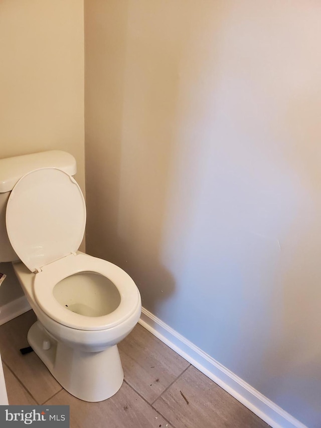 bathroom featuring hardwood / wood-style flooring and toilet