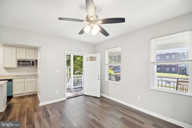 kitchen featuring ceiling fan, dark hardwood / wood-style flooring, white cabinetry, and appliances with stainless steel finishes