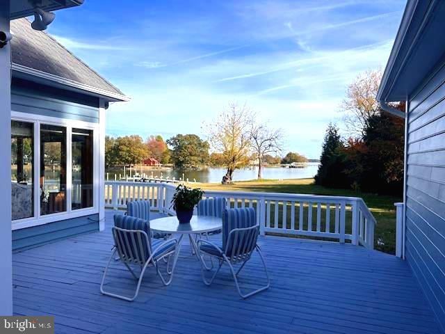 wooden terrace featuring a water view