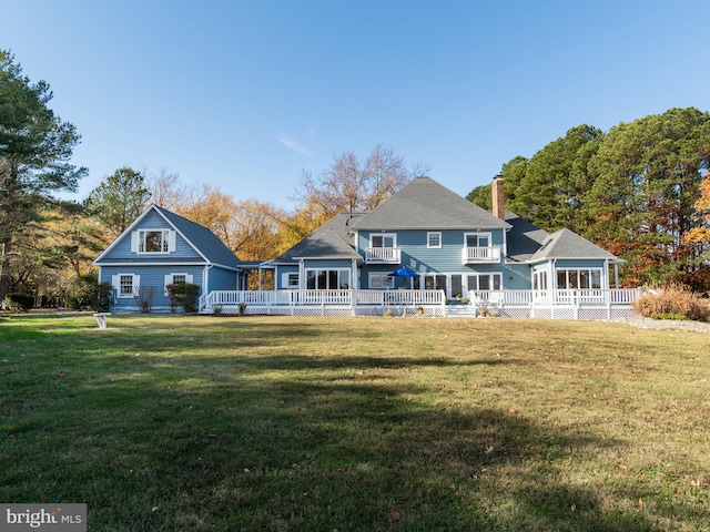 rear view of house featuring a yard