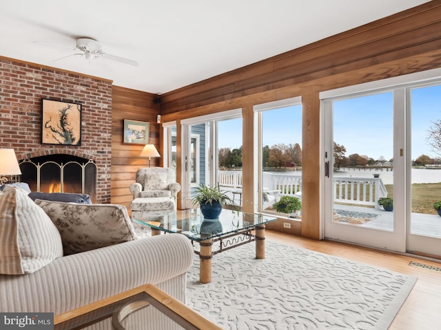 living room with hardwood / wood-style flooring, plenty of natural light, and a water view