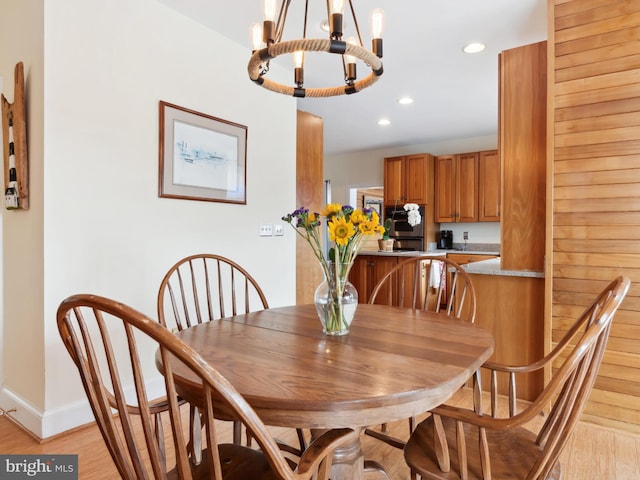 dining room featuring light hardwood / wood-style floors and a notable chandelier