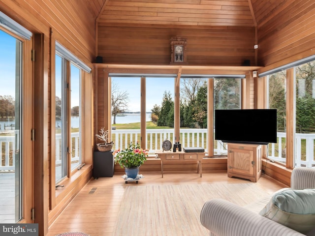 sunroom with plenty of natural light, lofted ceiling, and wood ceiling