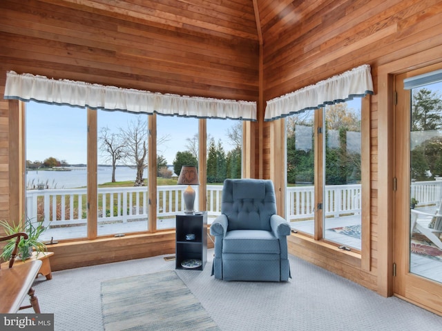 sunroom with a water view, vaulted ceiling, and wooden ceiling