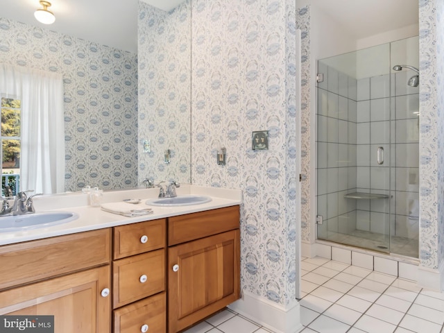 bathroom with tile patterned flooring, vanity, and a shower with door