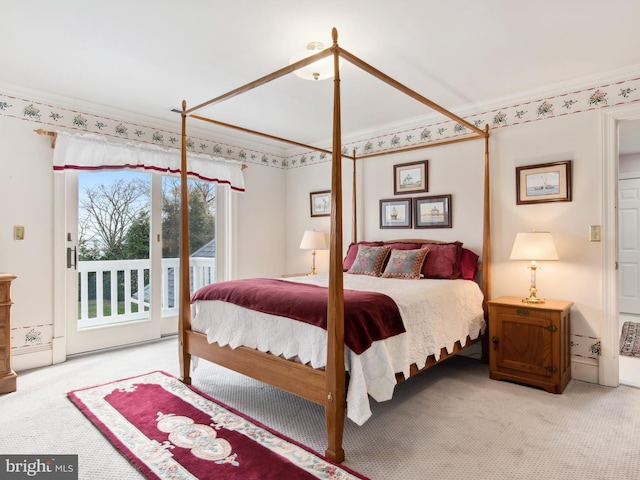 carpeted bedroom with access to exterior and crown molding