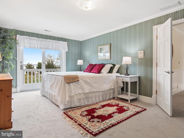 carpeted bedroom with access to outside and crown molding