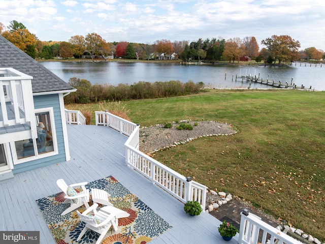 exterior space featuring a deck with water view