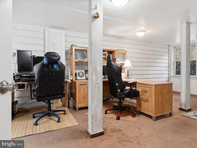 carpeted home office with wooden walls